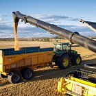 CR10.90 unloading into trailer on tramline, working in 12m controlled traffic system